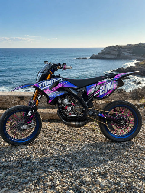 Supermoto with a blue and purple graphics kit