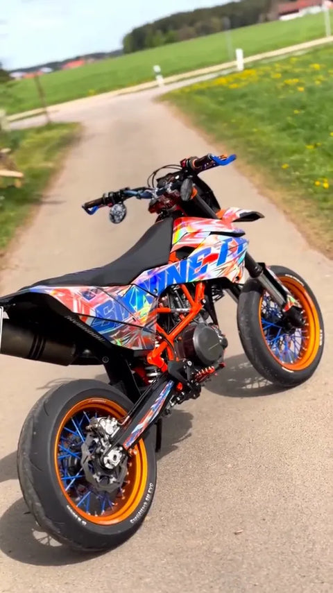 Supermoto with a orange and blue graphics kit