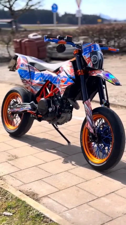 Supermoto with a orange and blue graphics kit