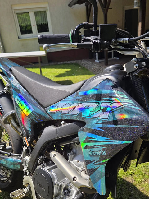 Dirt bike with a blue graphics kit, close-up