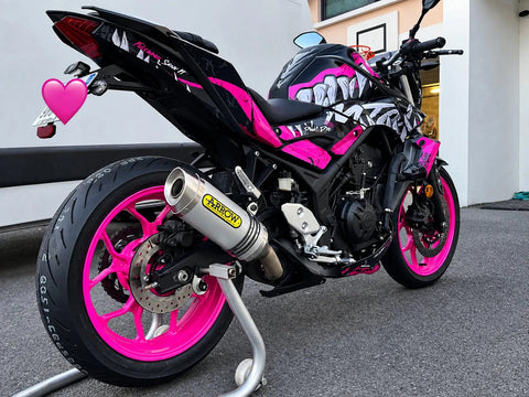Naked bike with a pink and black graphics kit