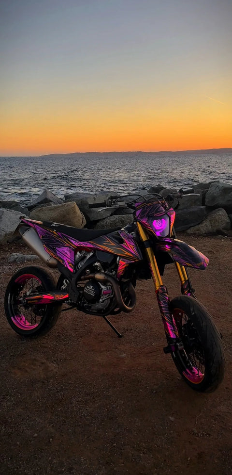 Supermoto with a pink and gold graphics kit