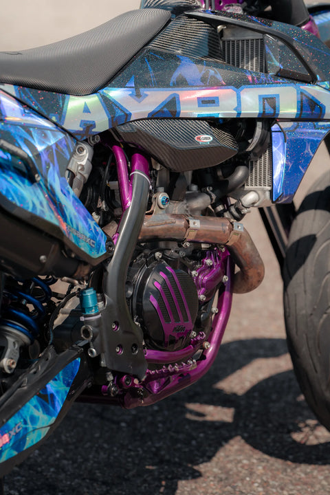 Supermoto with a blue and purple graphics kit