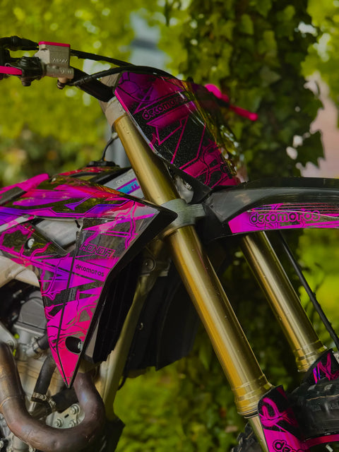 Dirt bike with a pink graphics kit